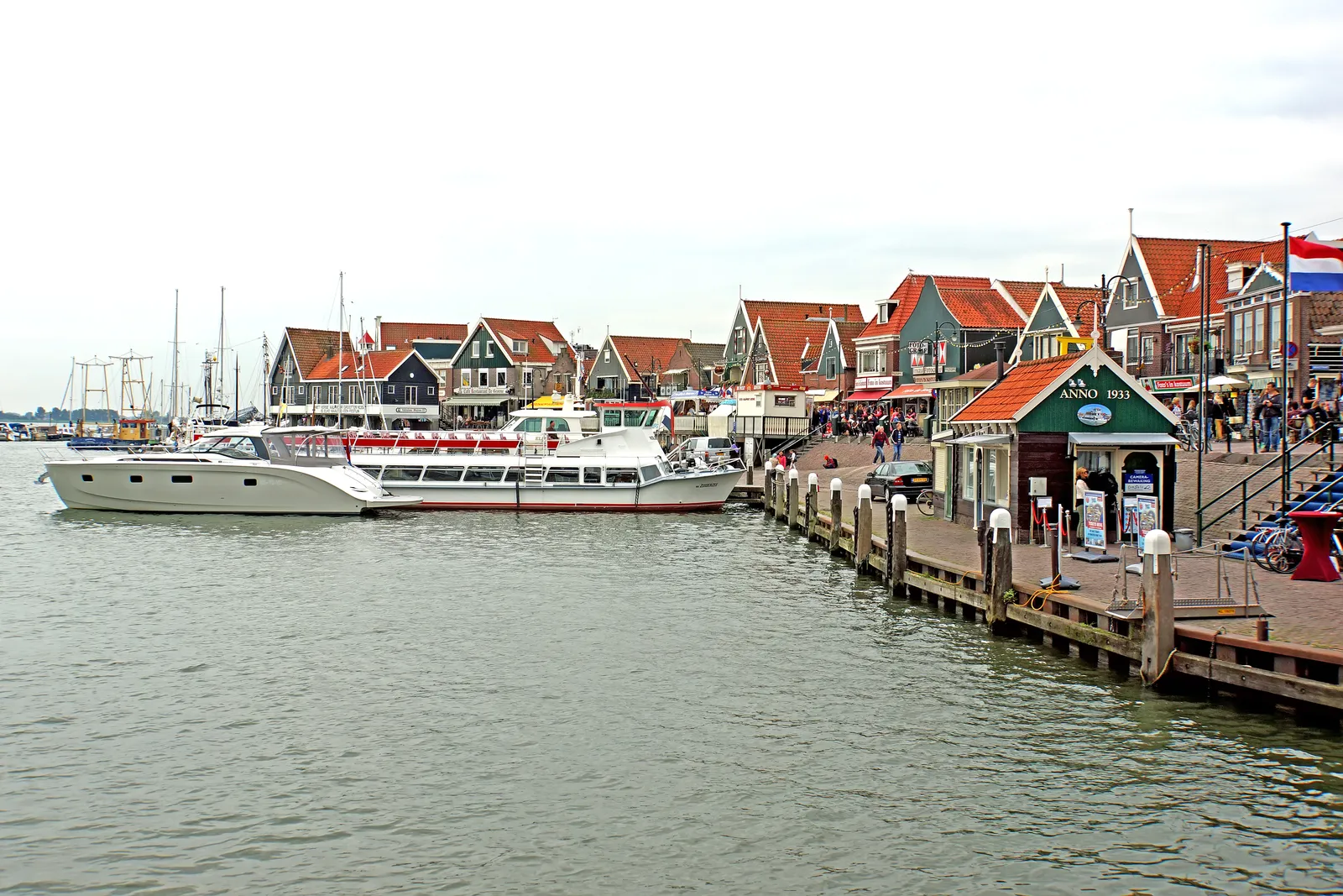Traditional wooden houses and boats at the harbour of Volendam, a Dutch fishing village