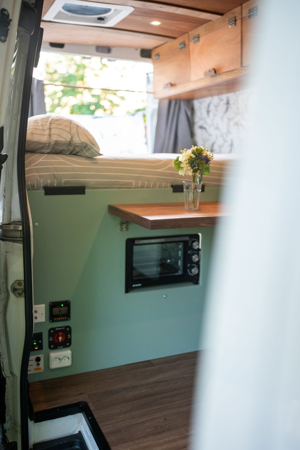 Horizon campervan interior — bed, oven and storage